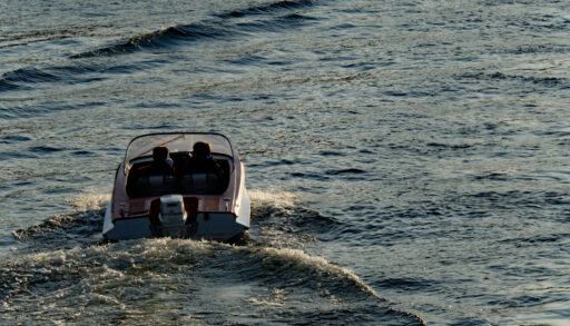 Small motor boat driving away