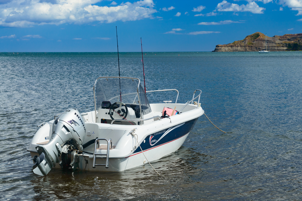 A small motor boat anchored in the lake