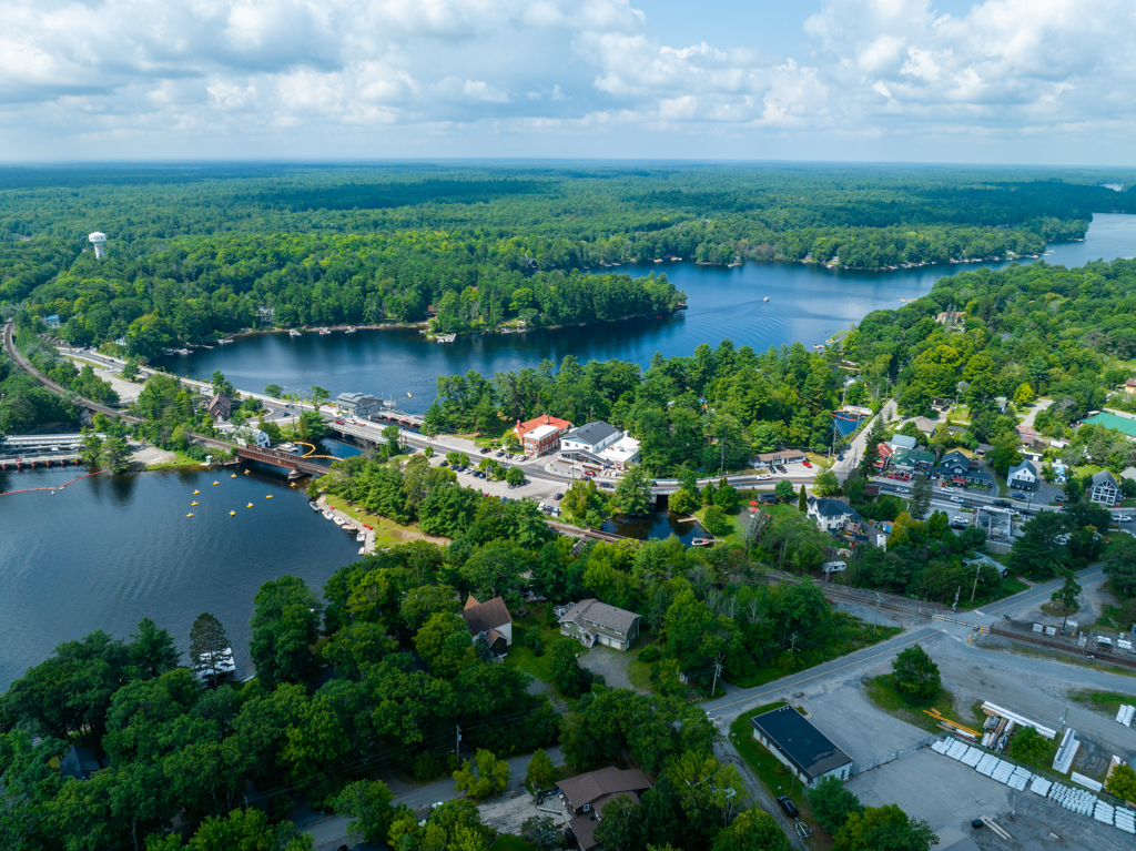 A road bridges two land formations across a lake.