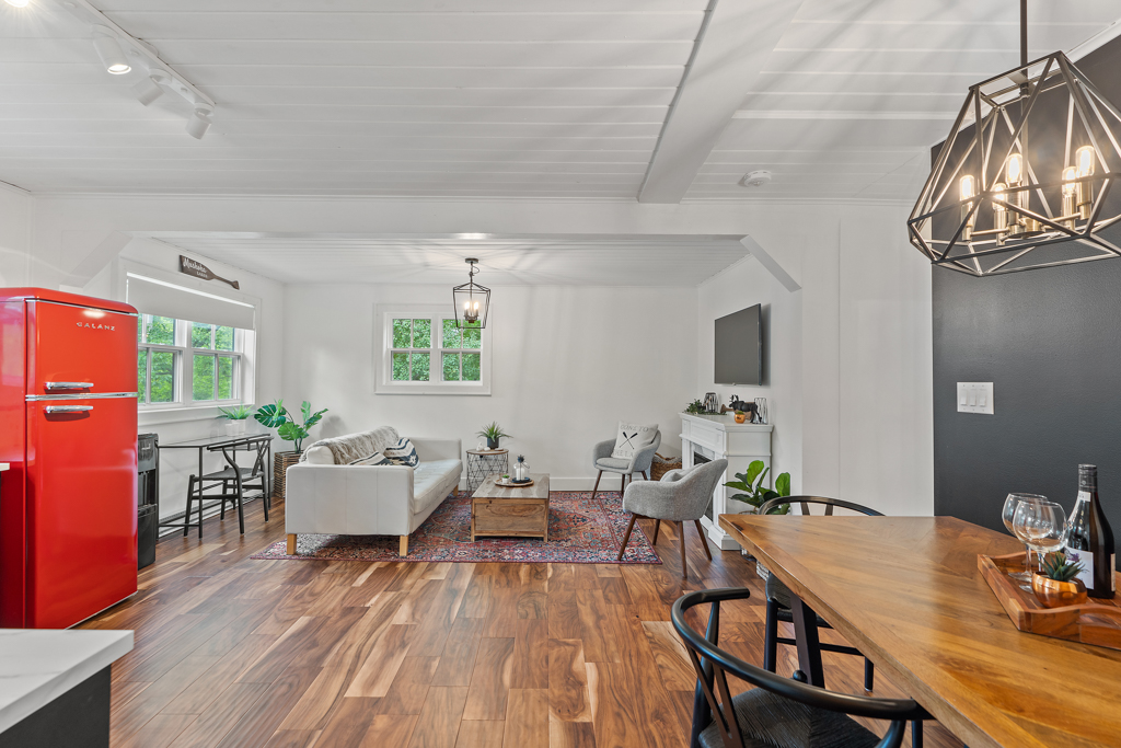 A bright, open-concept main floor of a small house, with hardwood floors.