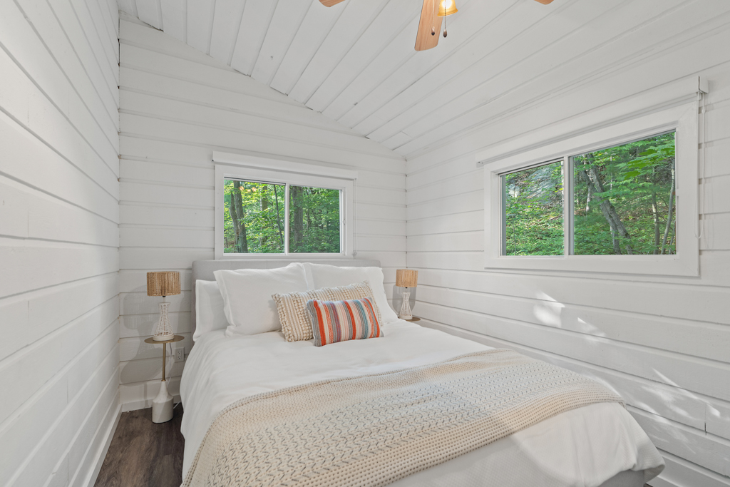 A small but bright bedroom with a sloping ceiling.