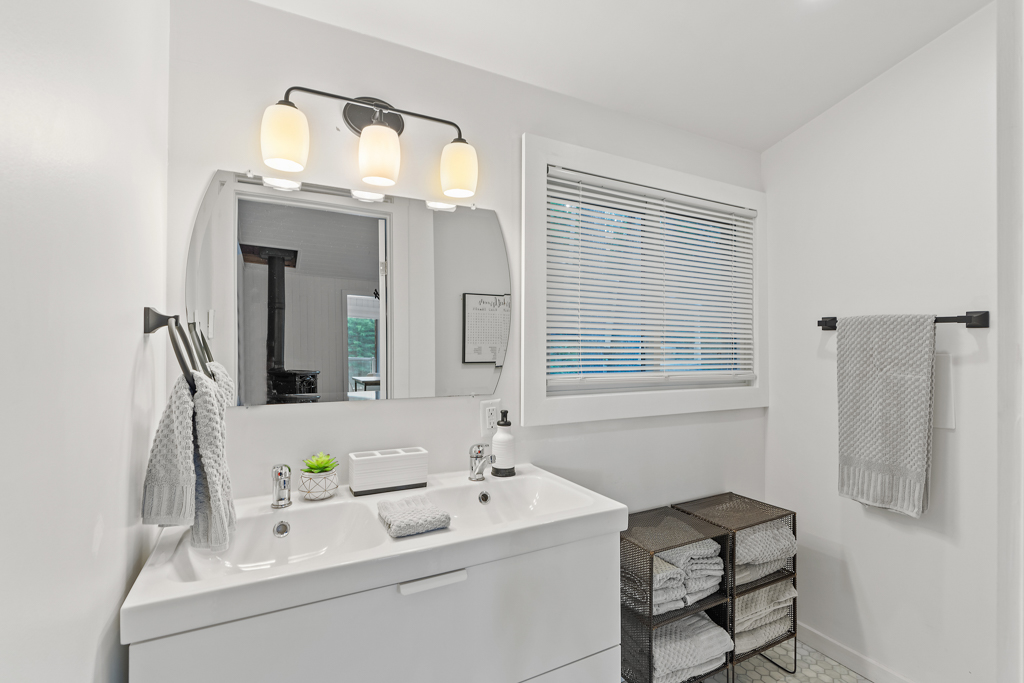 A big bathroom with a sink and a mirror.