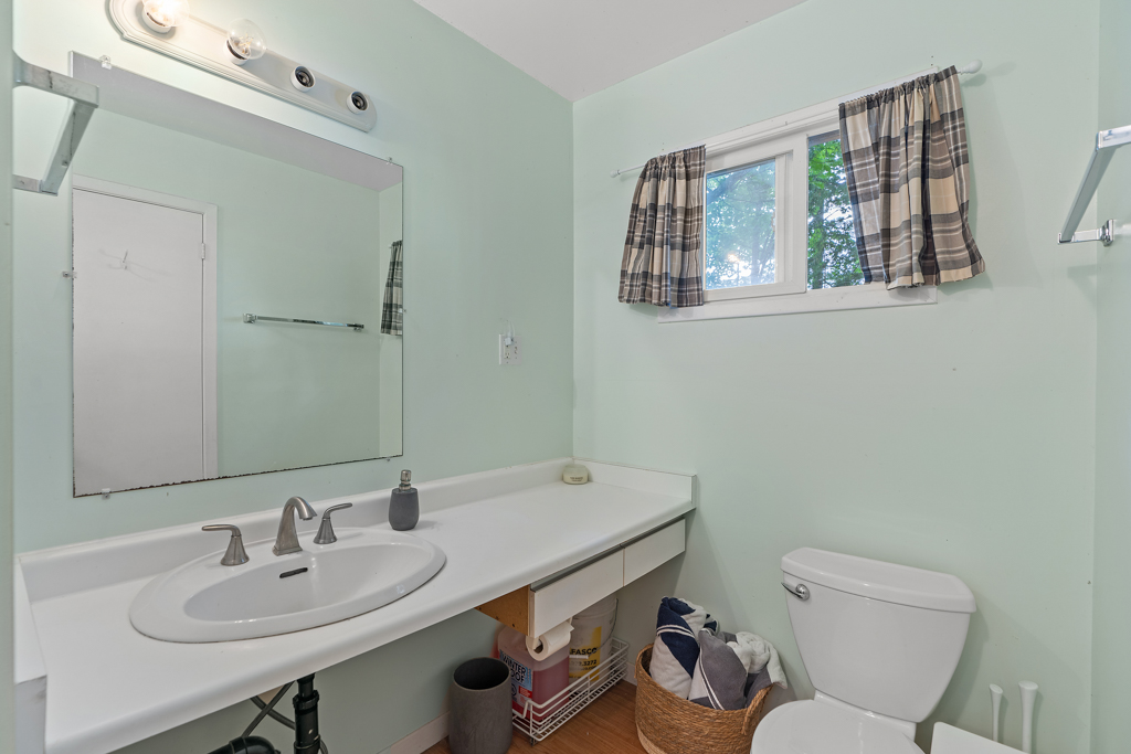 A bathroom with a toilet and a sink.