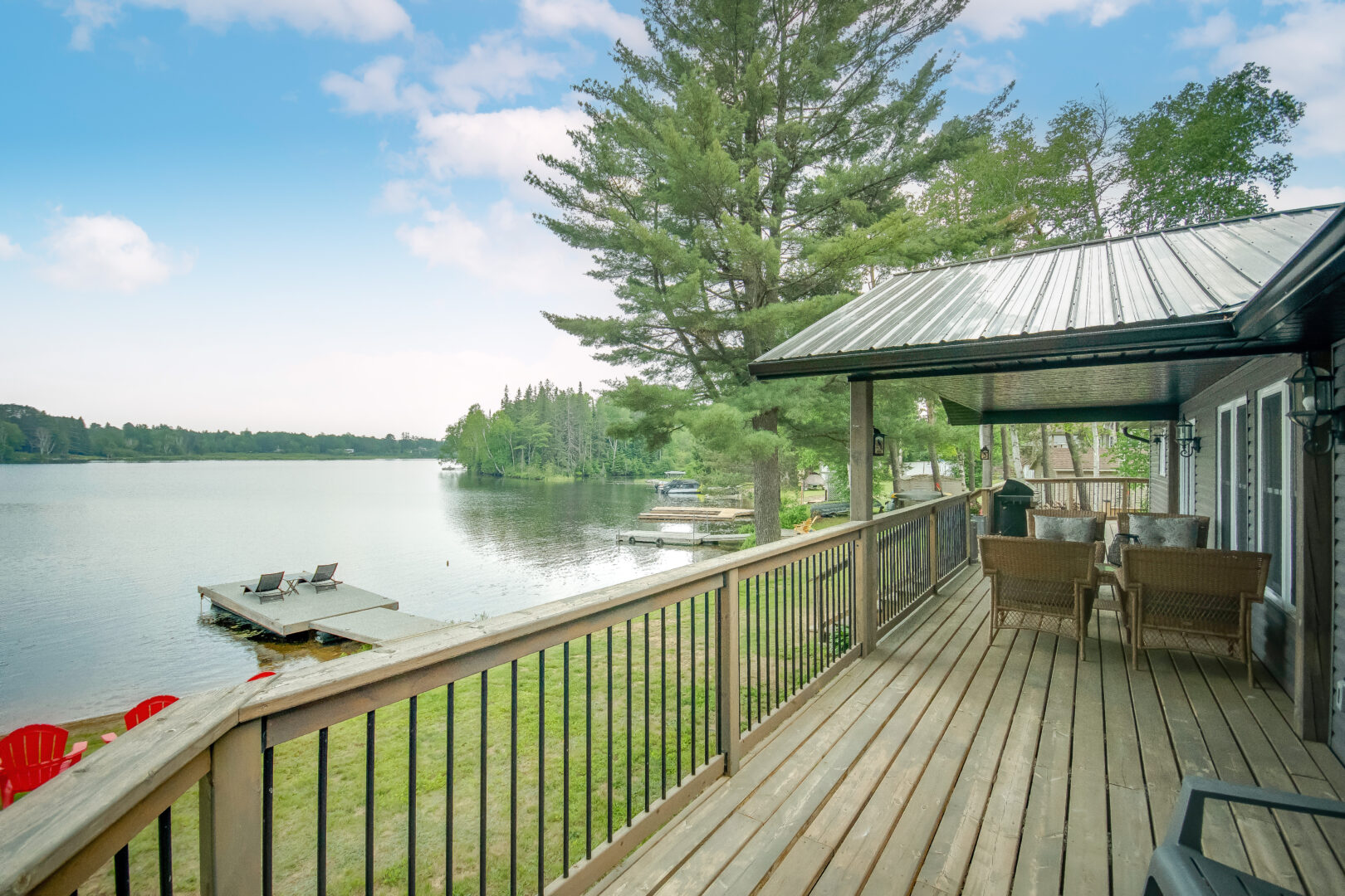 A wooden deck looks out over a lake.
