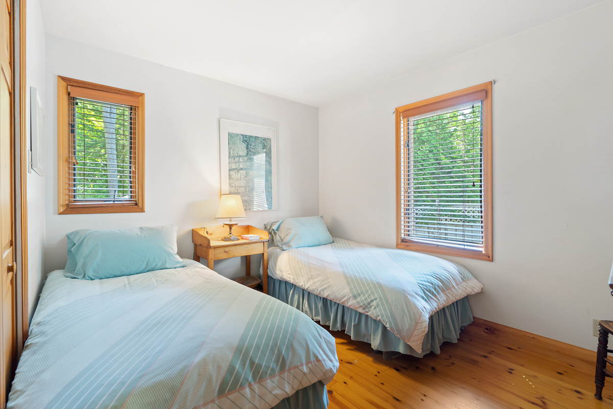A bright bedroom with two beds.