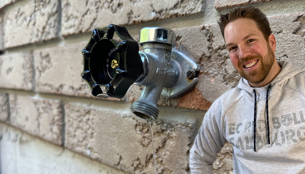 Cottage Coach superimposed on a brick wall with a tap