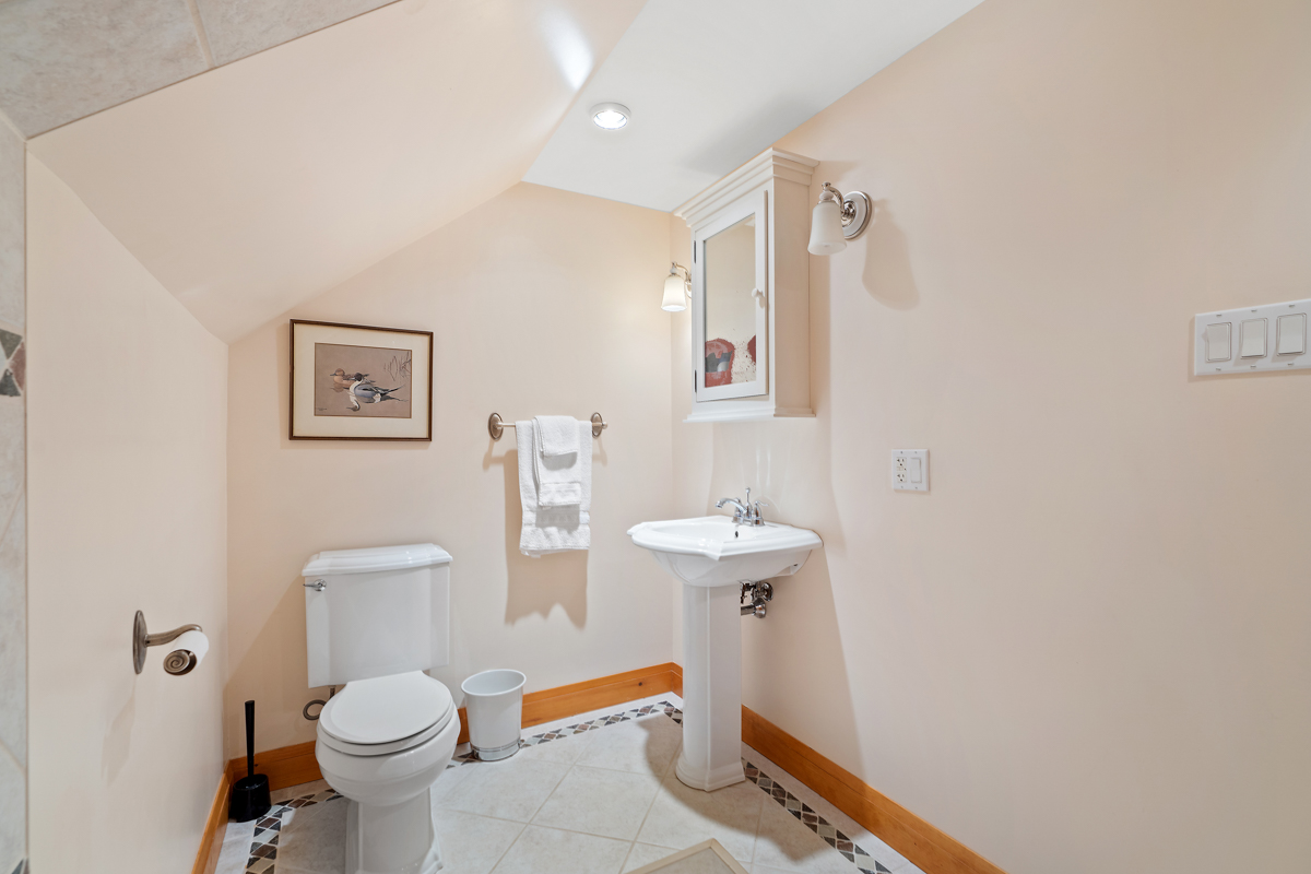 An ensuite bathroom with a toilet and a sink.