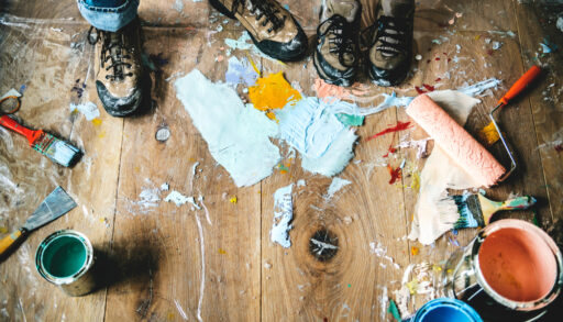 People renovating the house with paint all over the floor