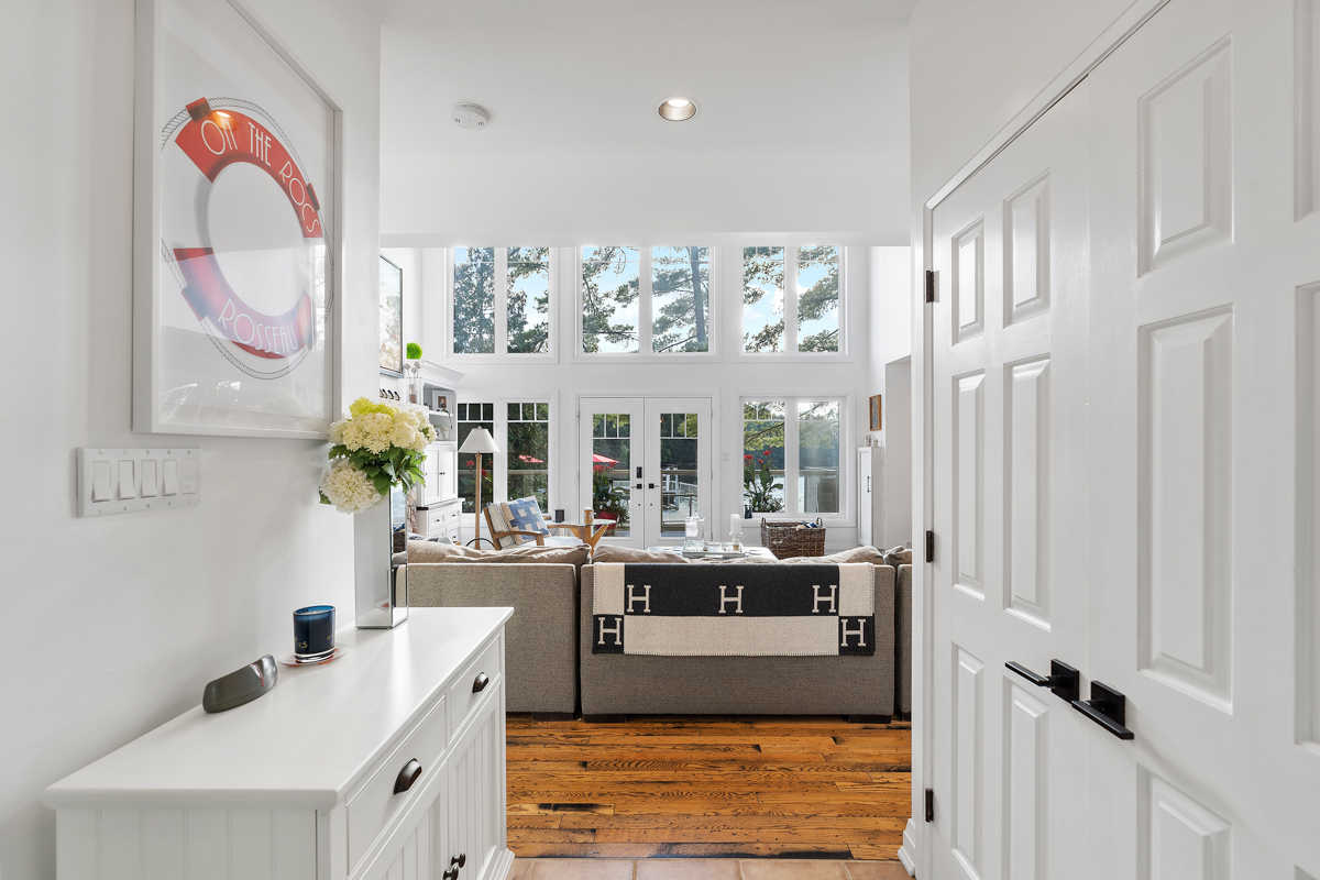 A bright entrance hall looking into a large living space.
