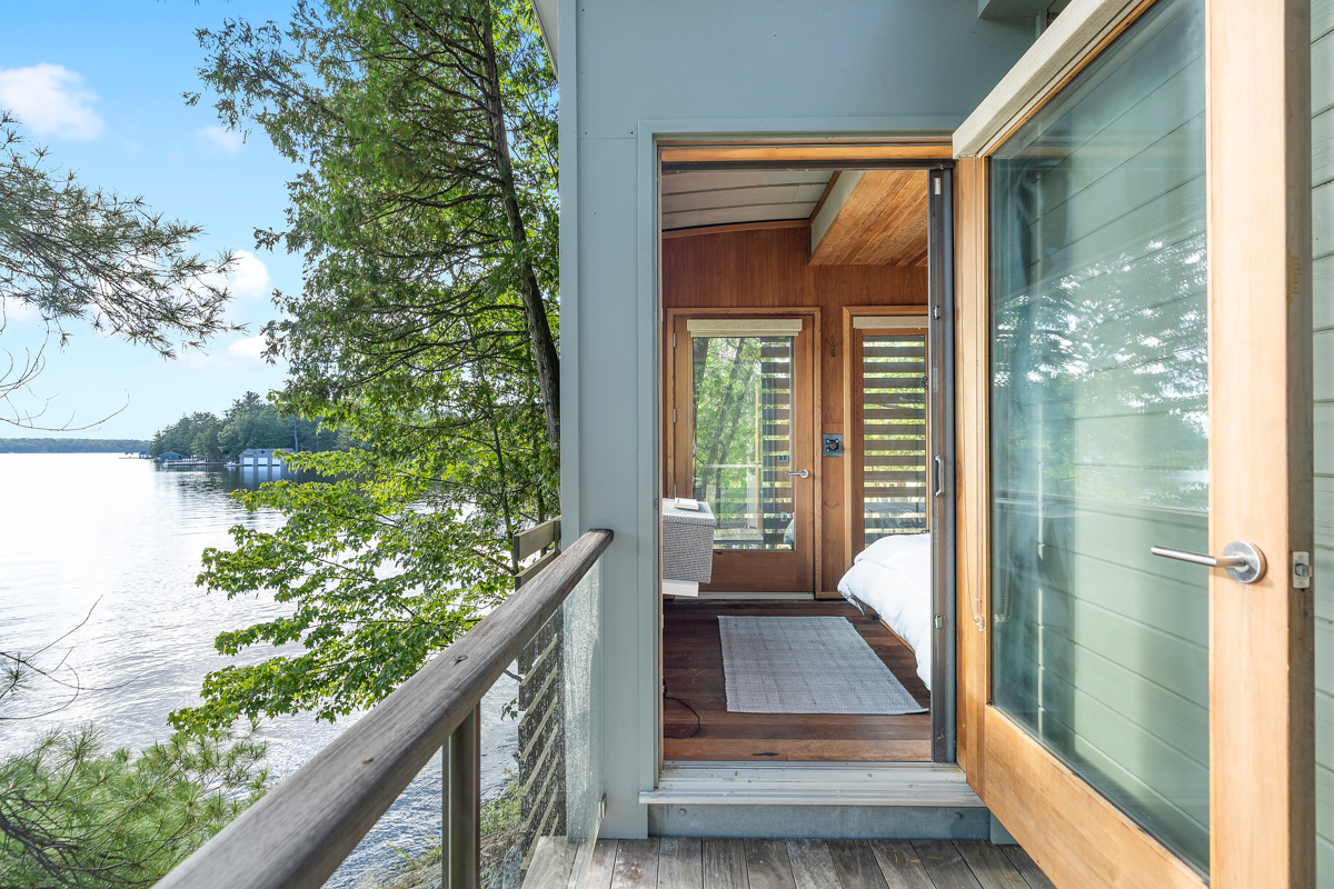 A path leads into a small waterfront bunkie.