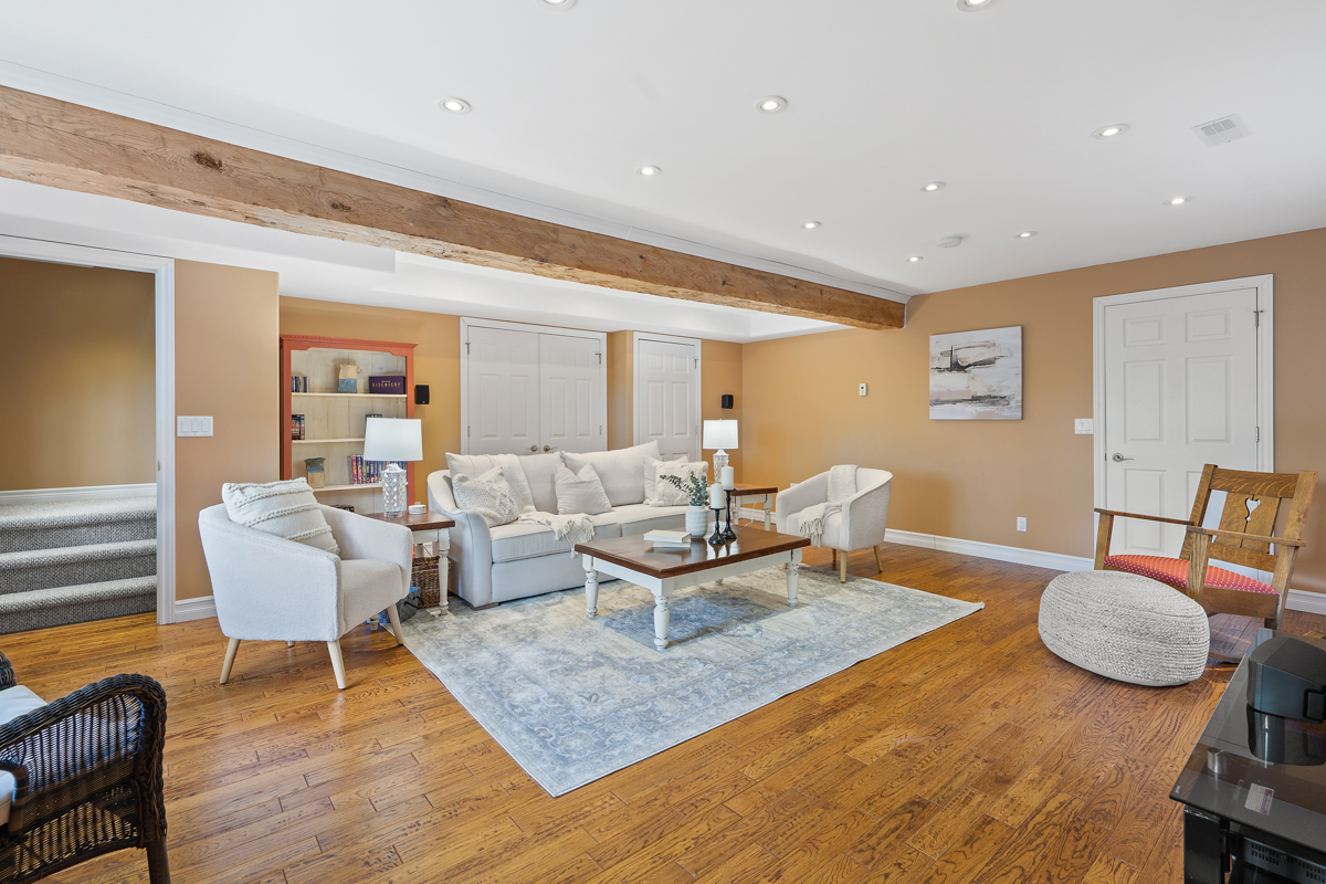 A bright living area with a couch and chairs.
