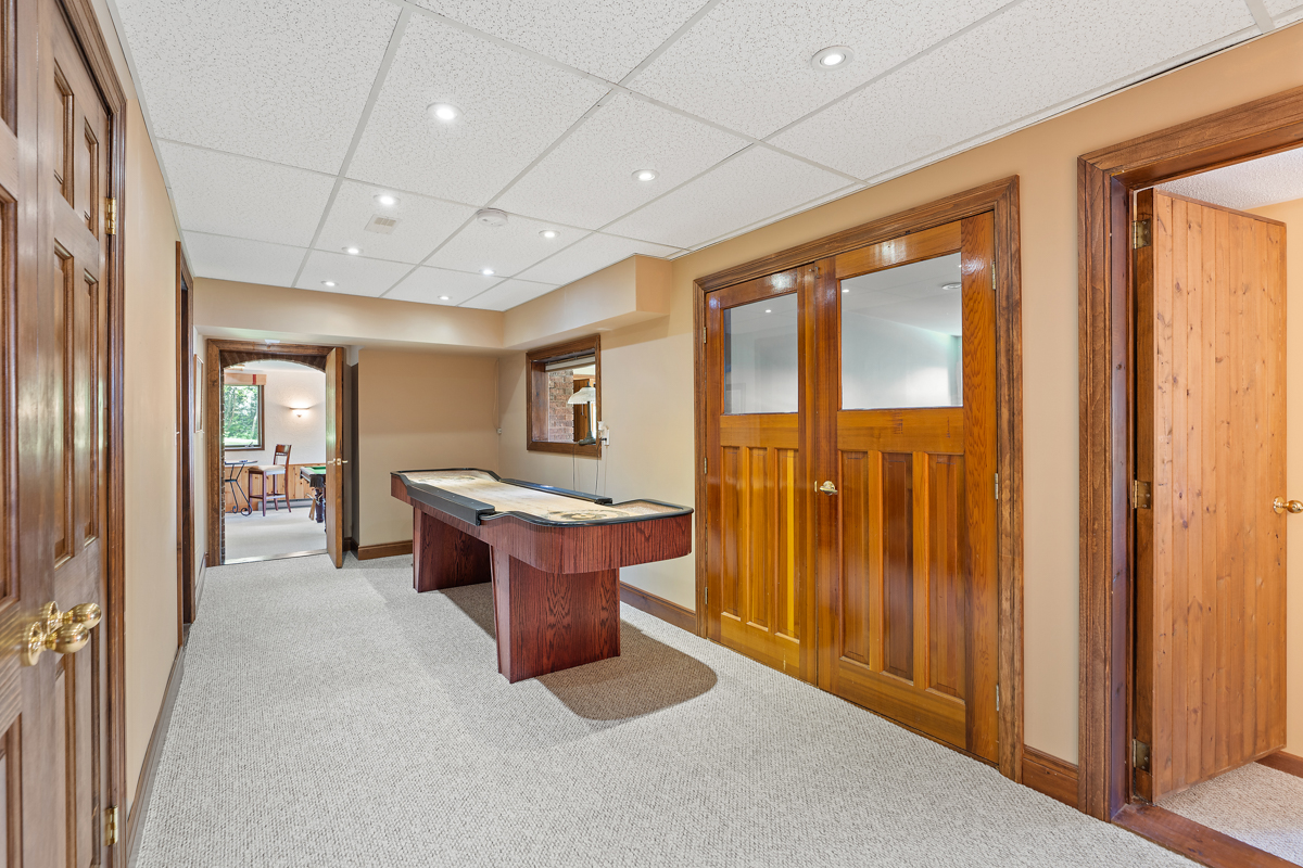 A narrow area with a table game and carpeted floors.