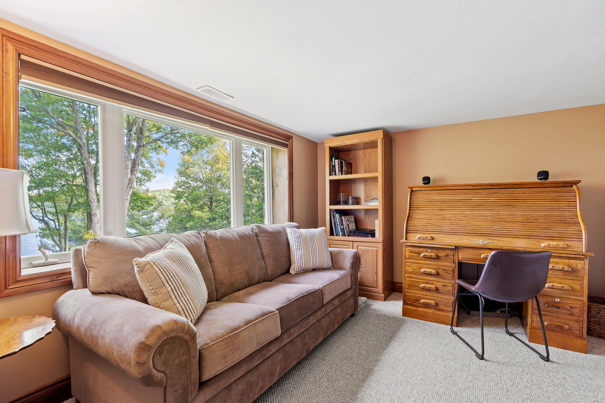 A cozy living space with a couch and a desk.