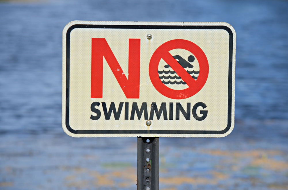 no swimming sign on a beach