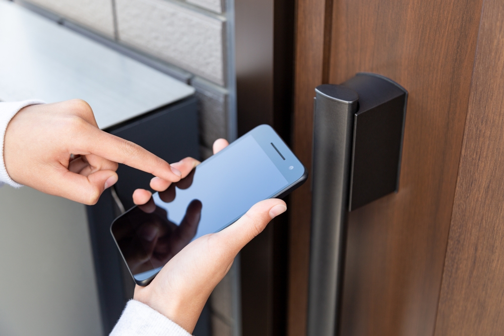 person unlocking door with a smartphone