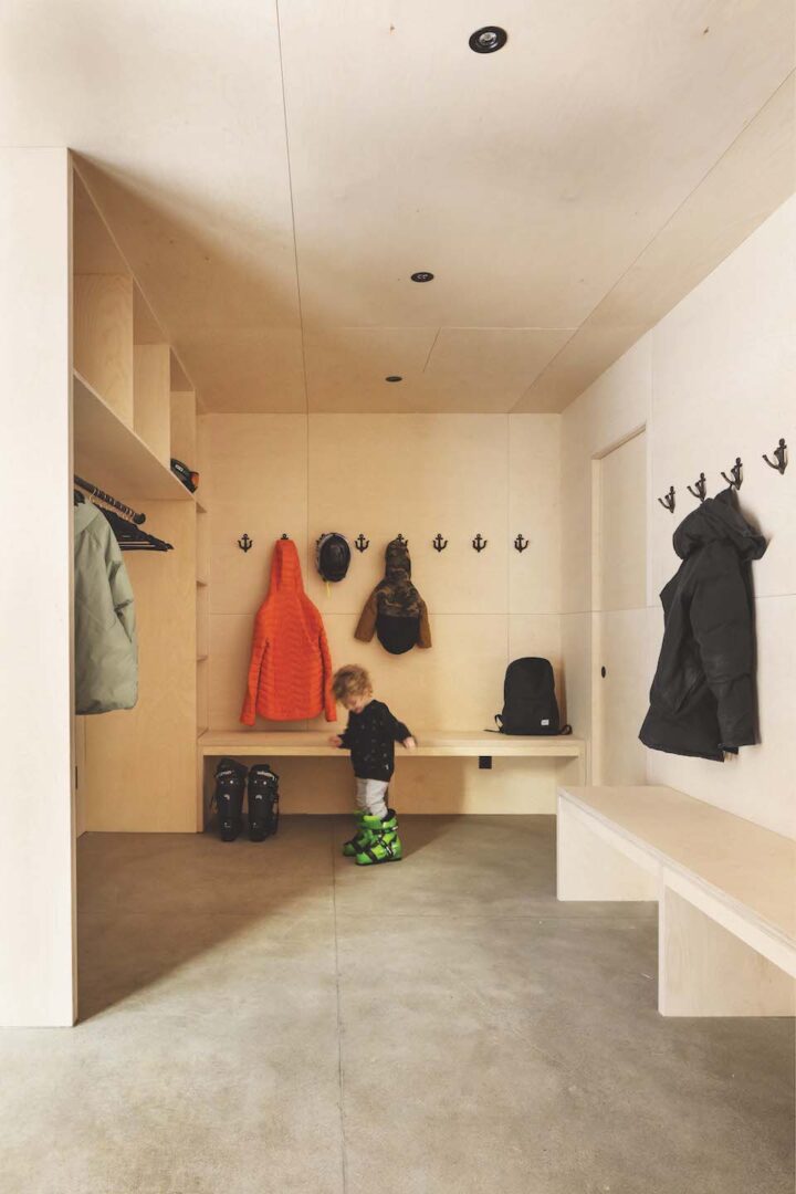 A photo of a plywood-clad mudroom