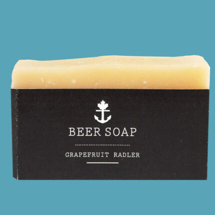 Orange bar of soap in black packaging