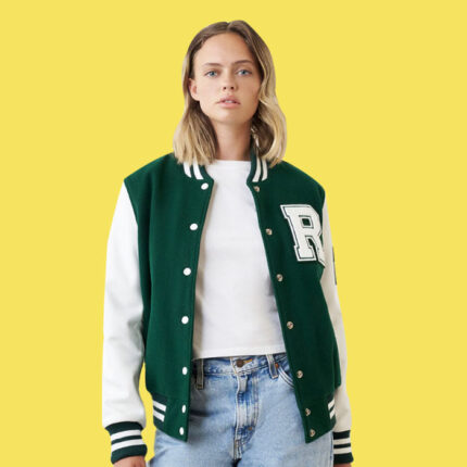 Woman wearing a green and white leather jacket with an R patch on the front