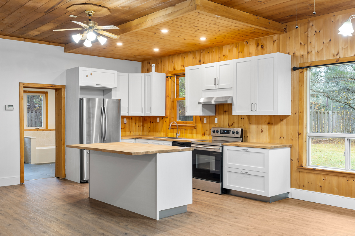 A bright kitchen with a large island and updated appliances.