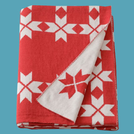 a red and white blanket on a blue background