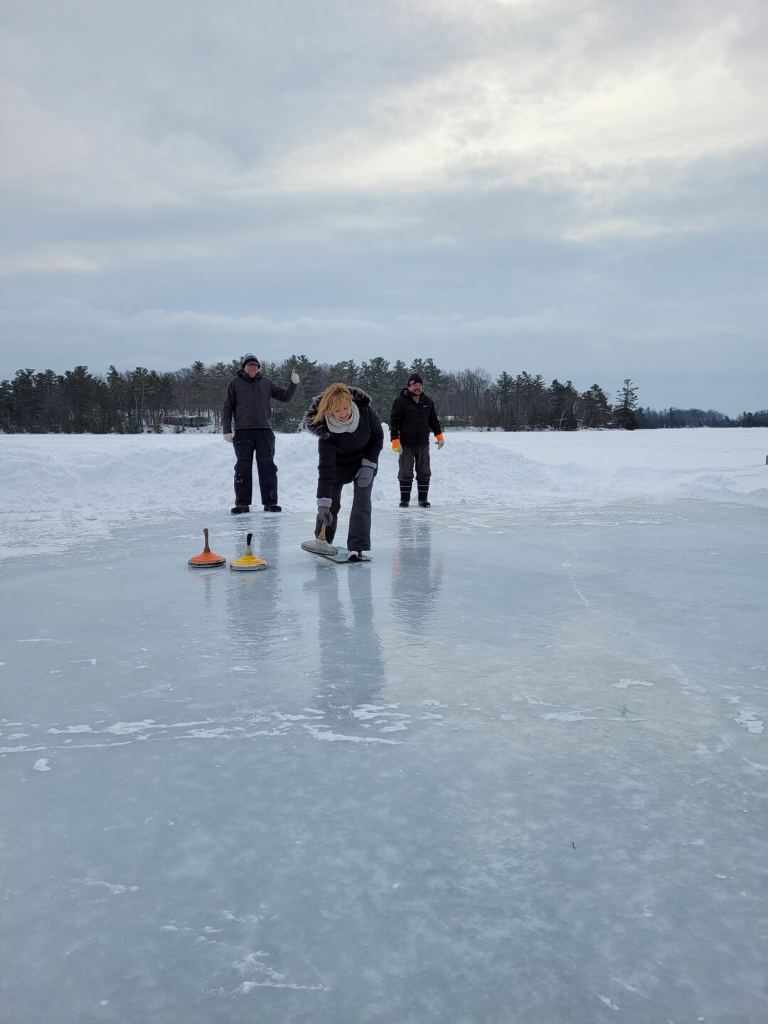 a woman playing ice stock sport
