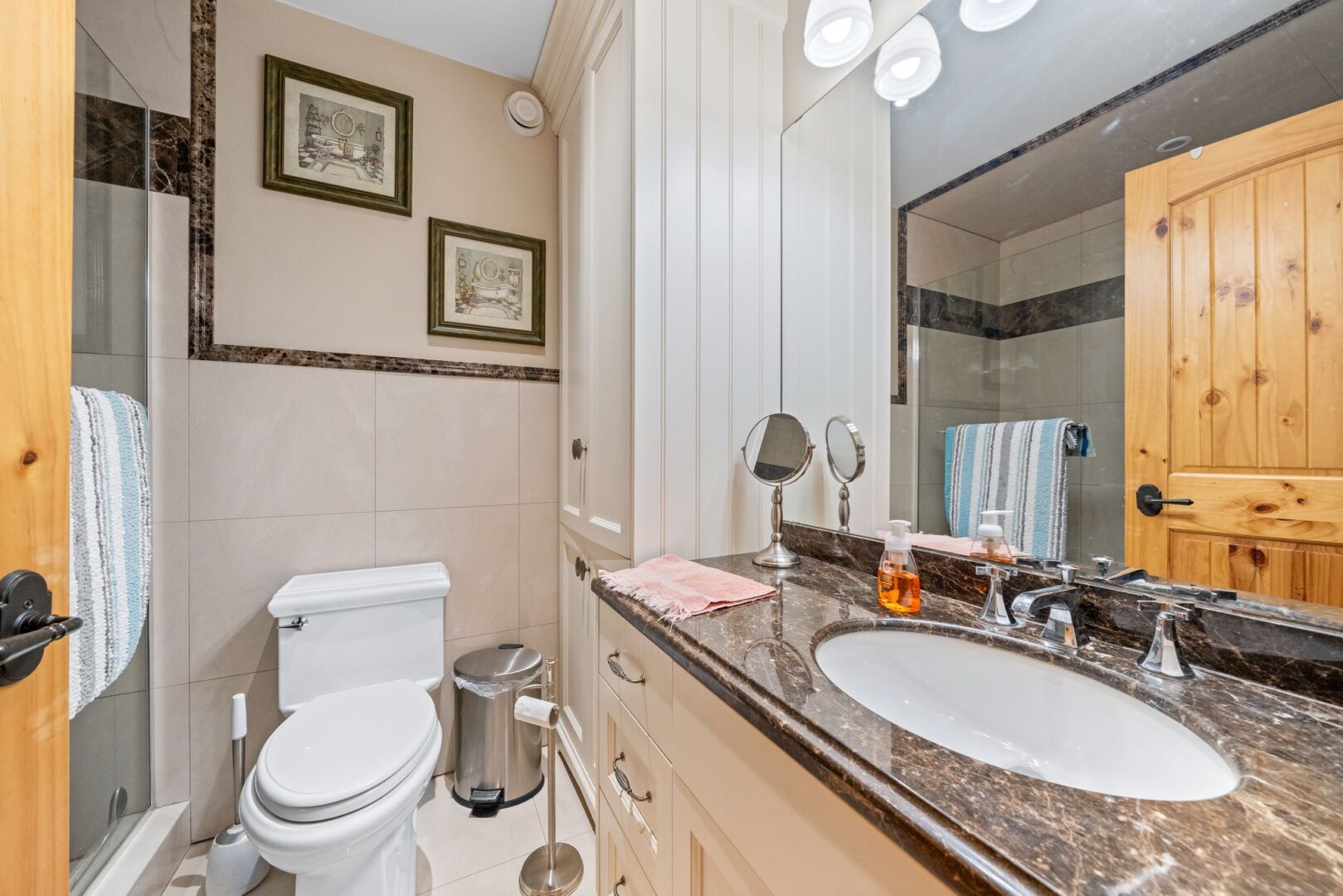 A three-piece bathroom with a sink, a toilet, and a shower-tub combo.