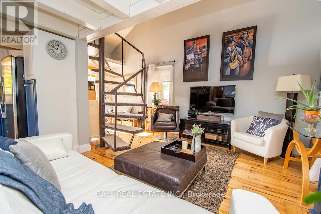 Spiral staircase leading up to a half loft in the cottage