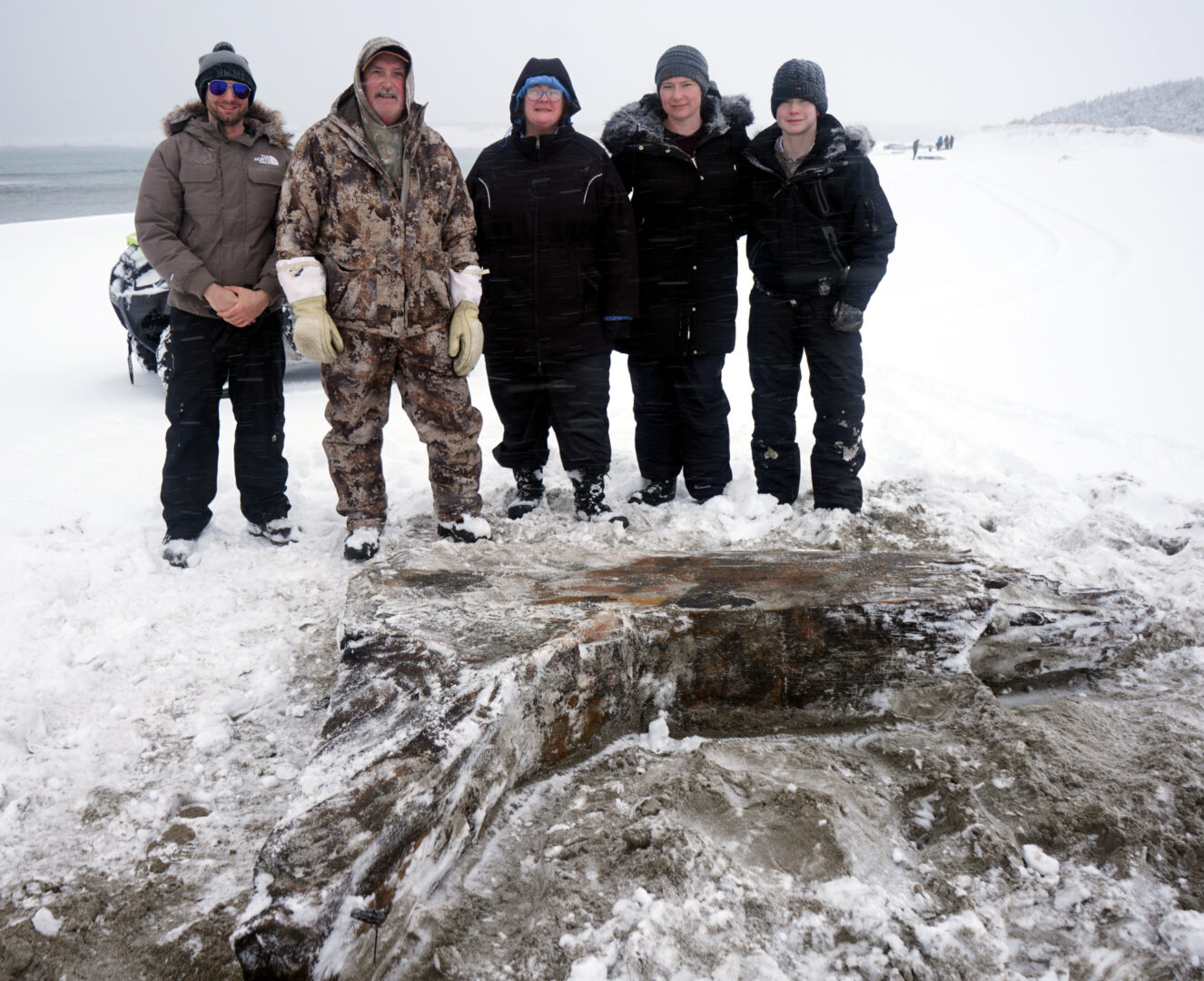A group standing near the wreck.