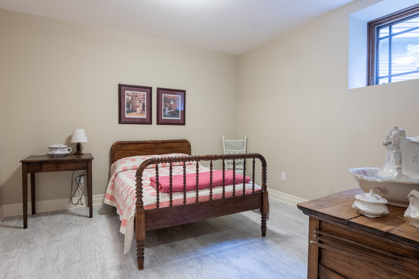 A bedroom with a double bed and antique-looking furnishings.