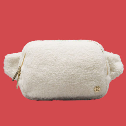 a white fluffy belt bag against a red background