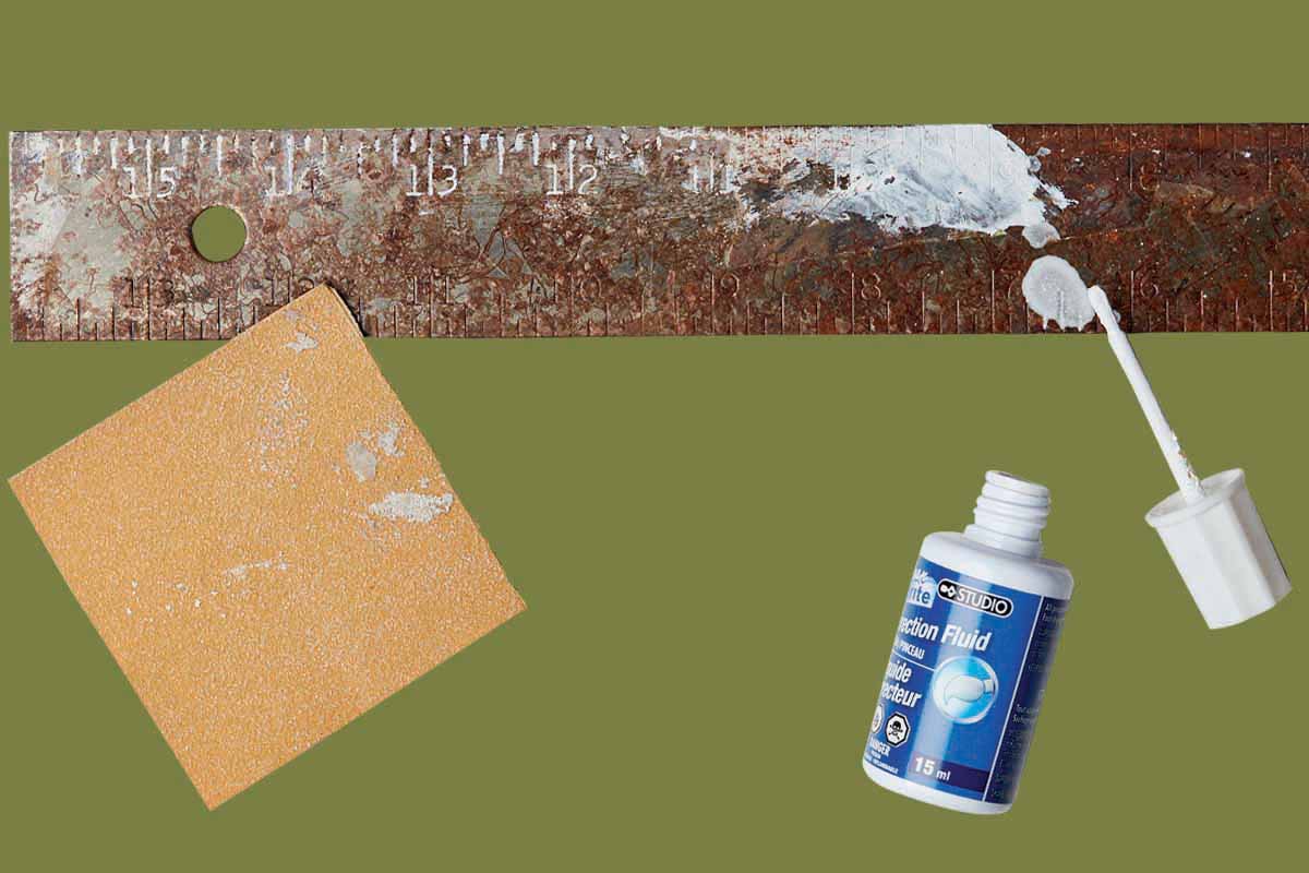 A ruler marked up with correction fluid, alongside sandpaper