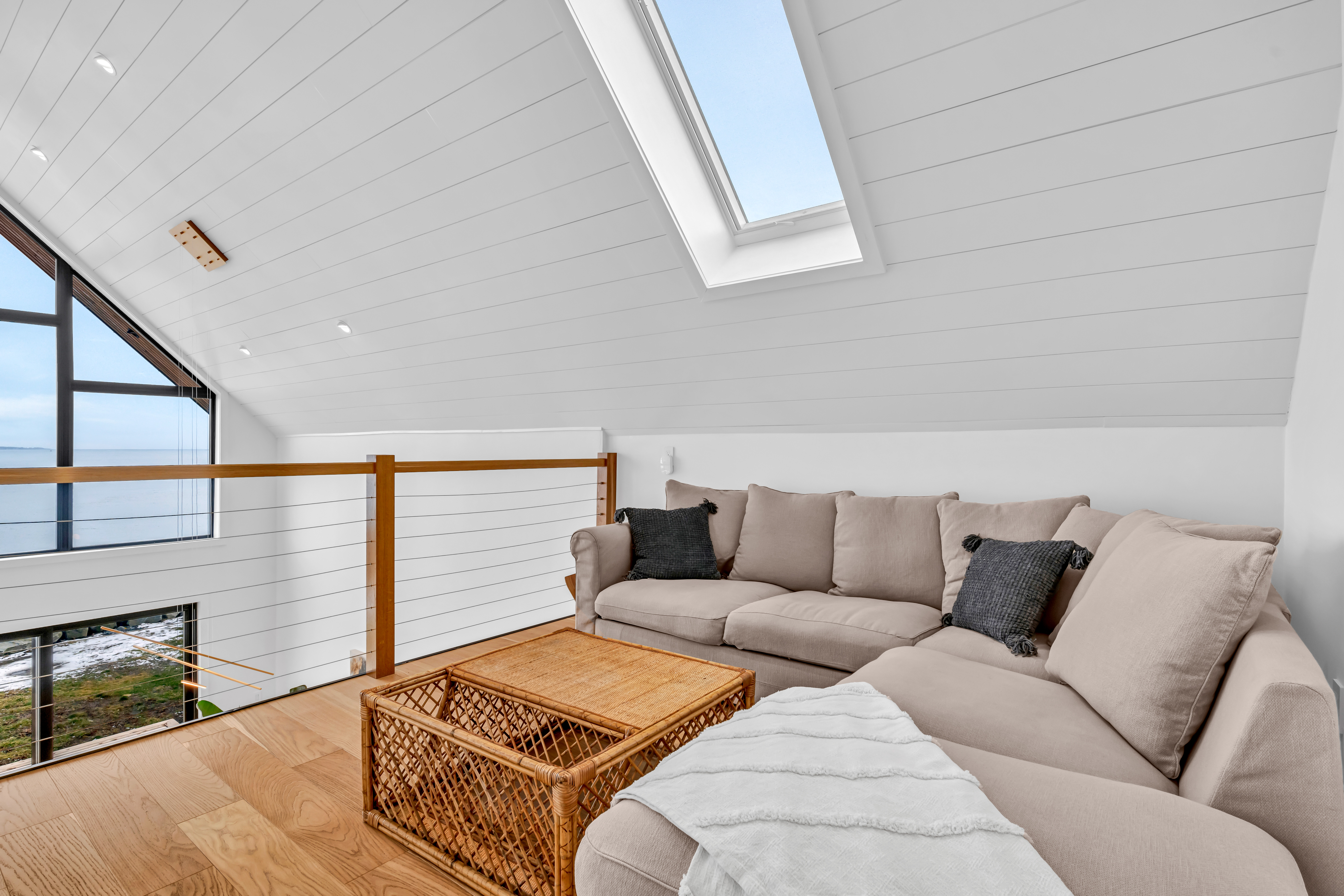 A small loft-level living space with a sectional couch.