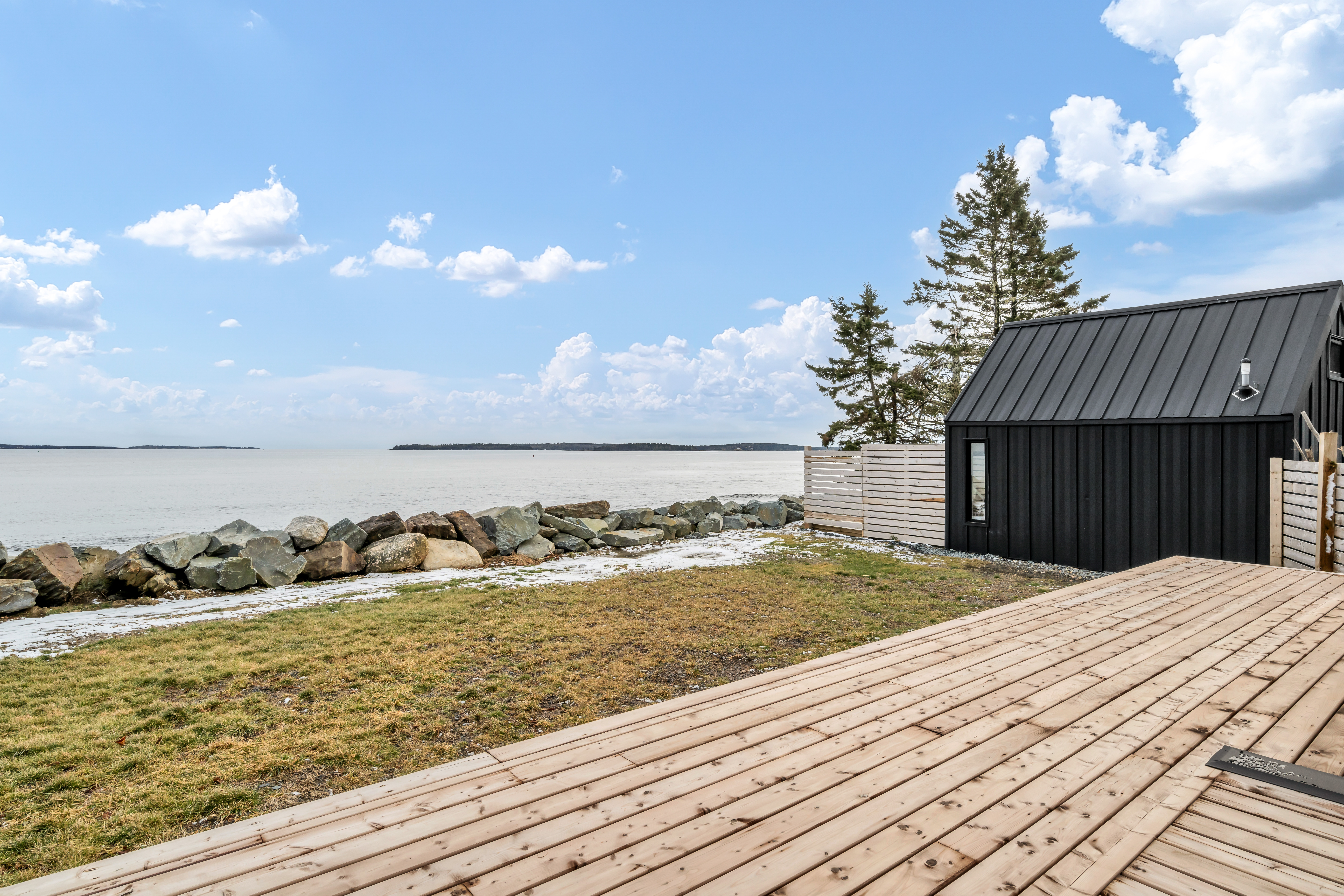 A wooden deck with an ocean view.