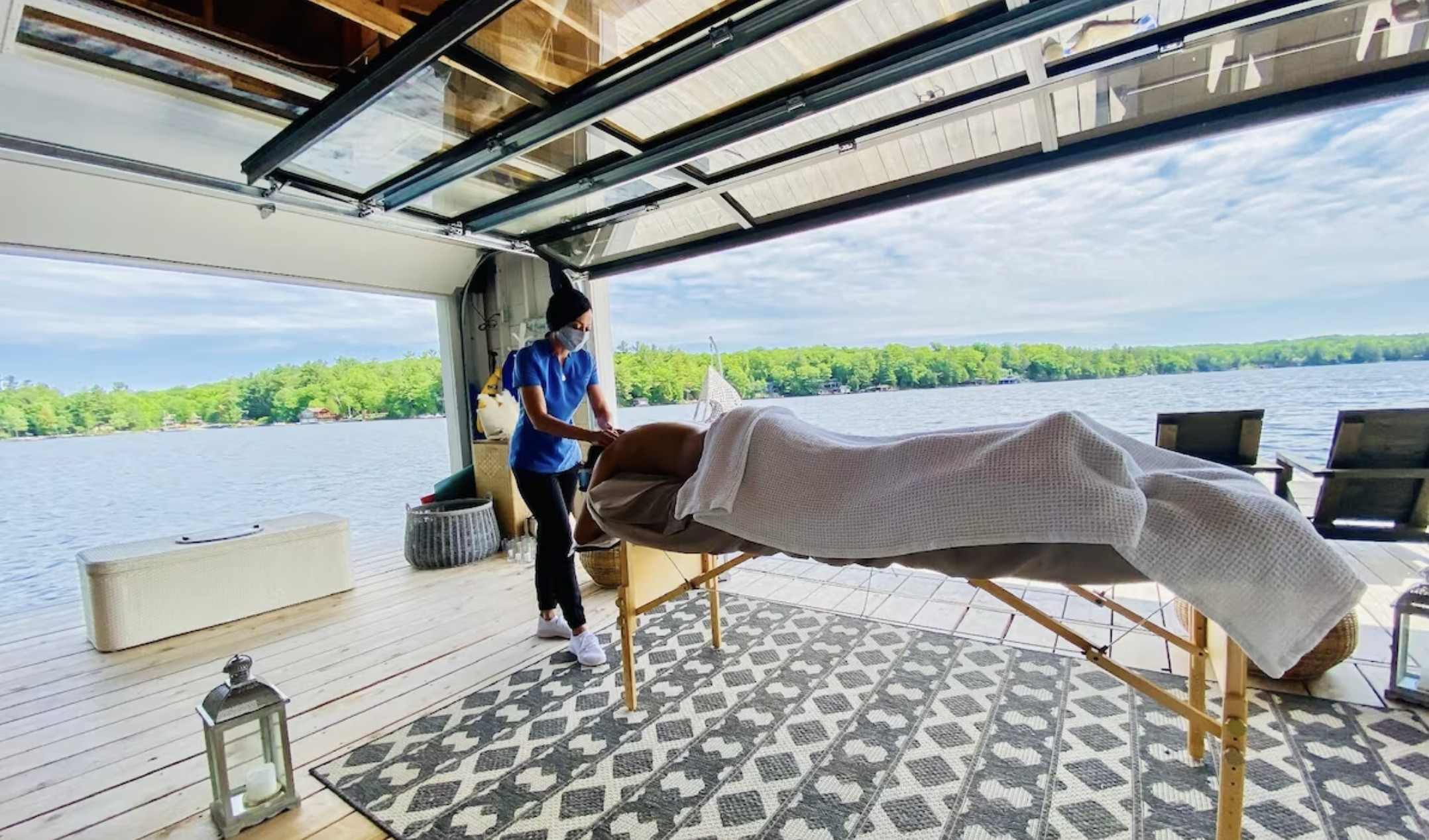 a person gets a massage on the dock with the lake in the background