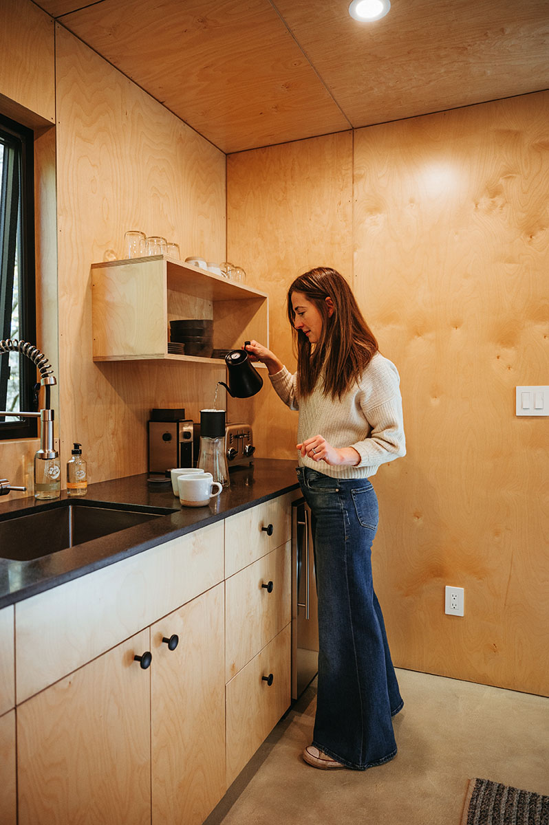 Lauren pours coffee at her kitchen counter.