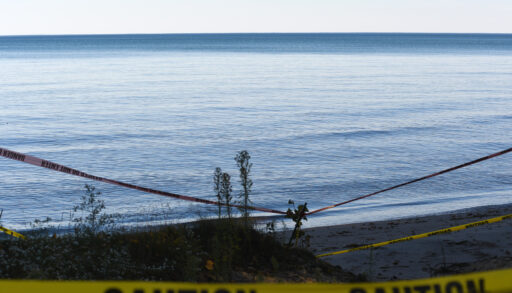 Caution tape blocks off access to a lake