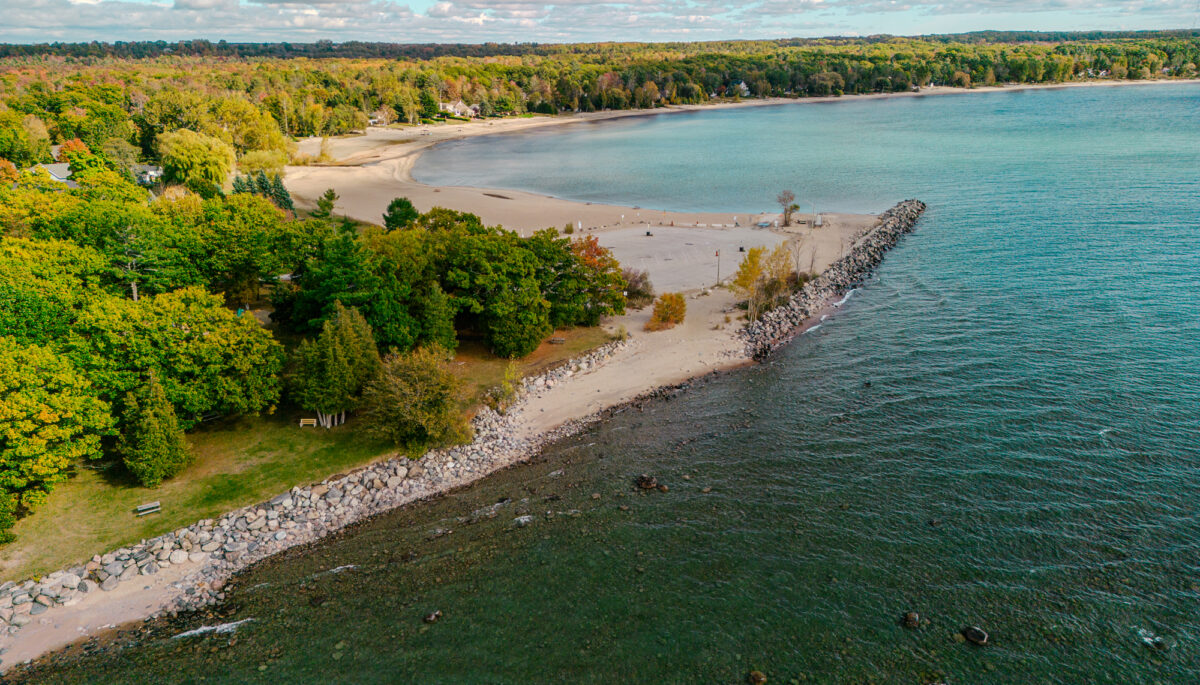 Aerial view of Jackson's Point that shows the lake, shoreline and cottages in the distance