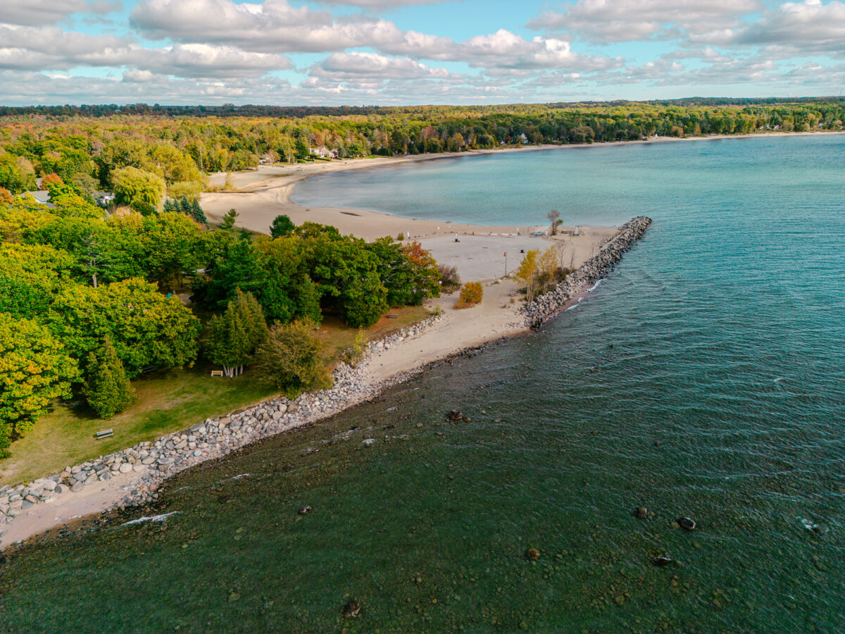 Aerial view of Jackson's Point that shows the lake, shoreline and cottages in the distance