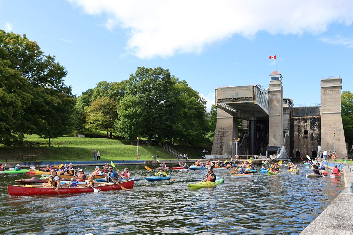 people in kayaks and canoes on the trent-severn waterway in peterborough