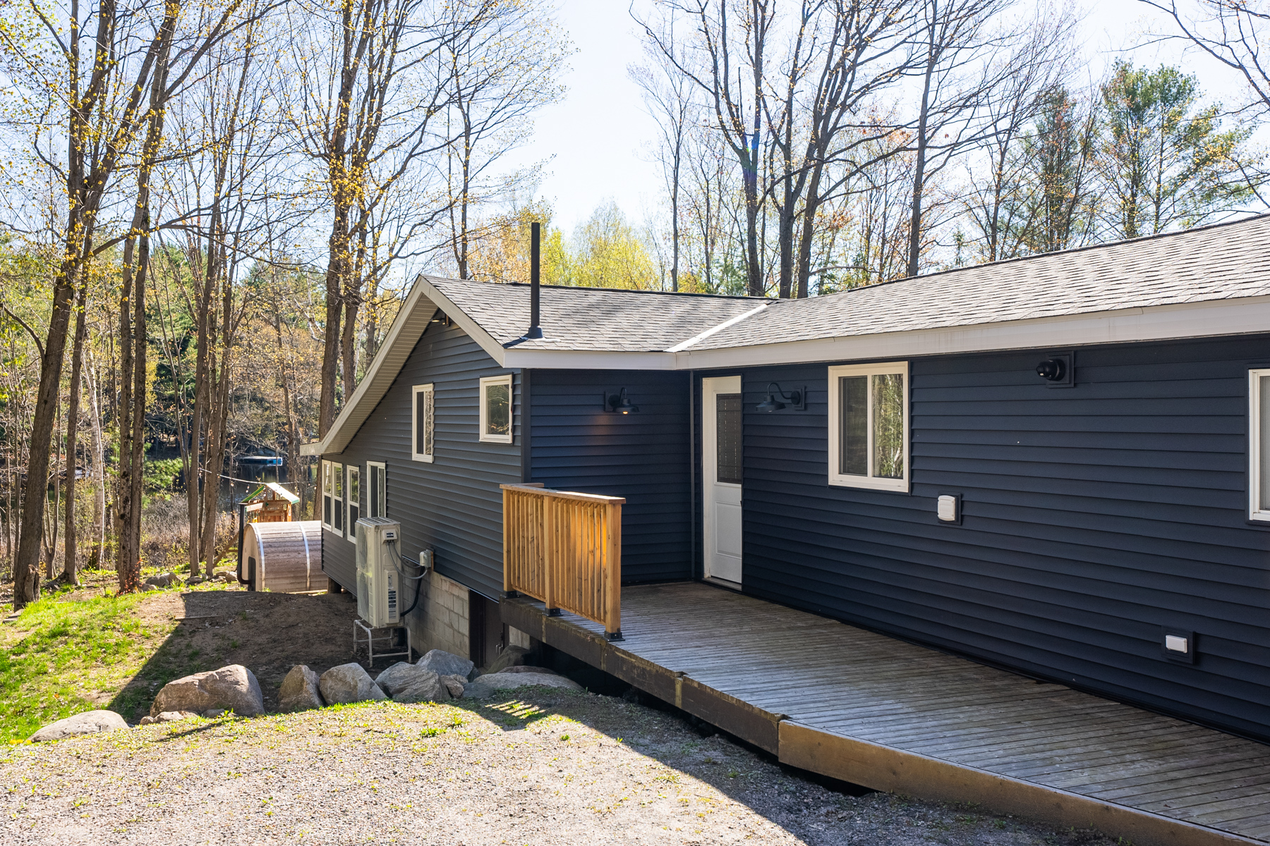 A small wooden porch leads to a white front door on a cottage bungalow.