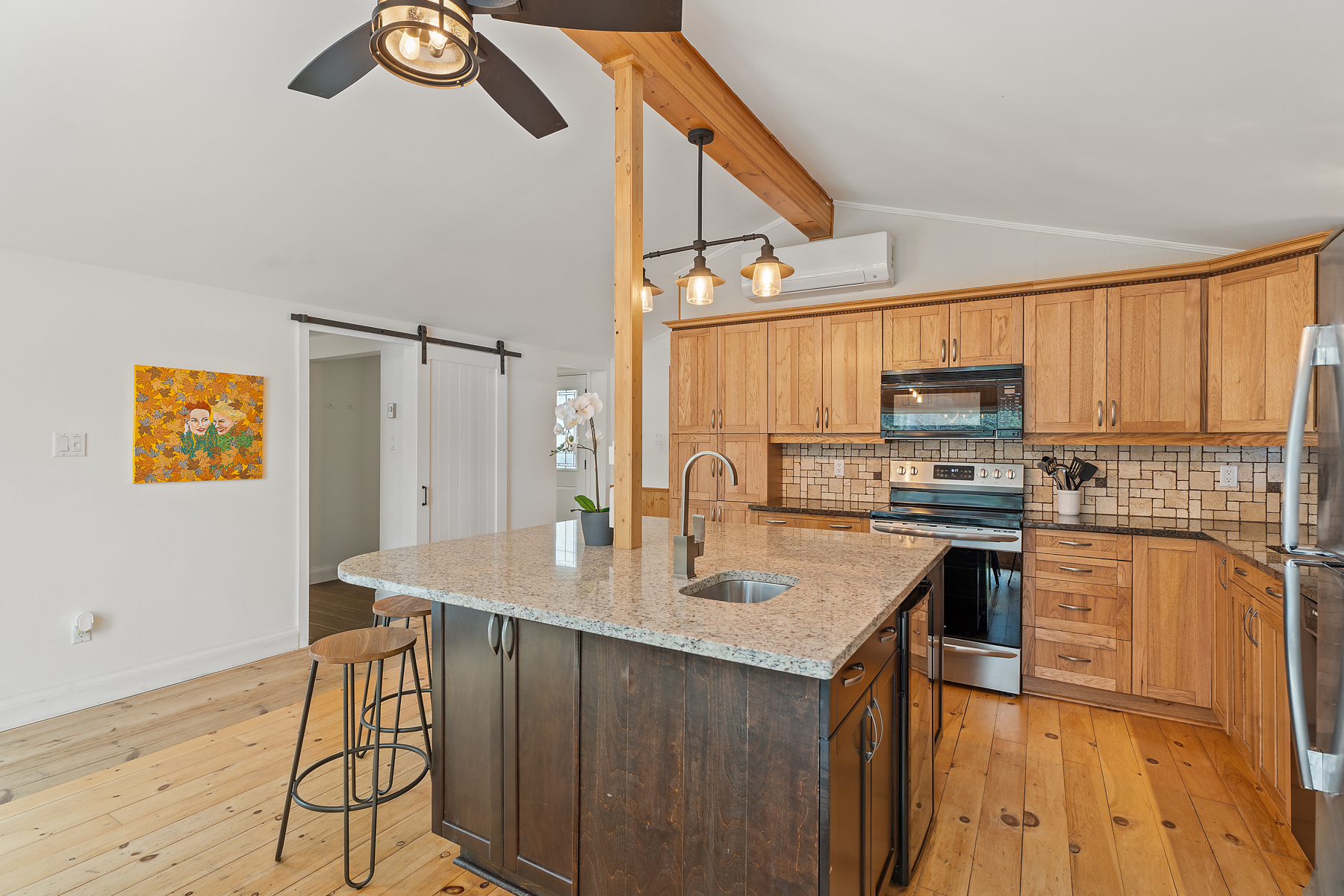 A big kitchen with a large island, lots of cabinetry, and updated appliances.