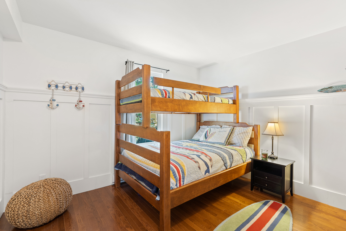 Brown bunkbeds with colourful striped bedding