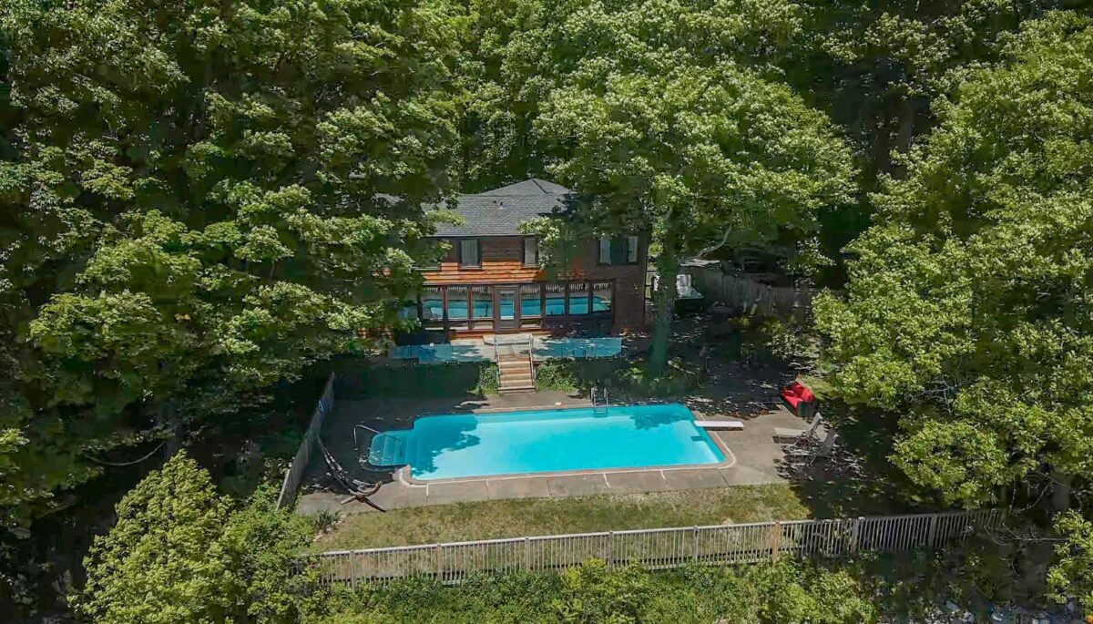 an aerial view of a property with a backyard pool