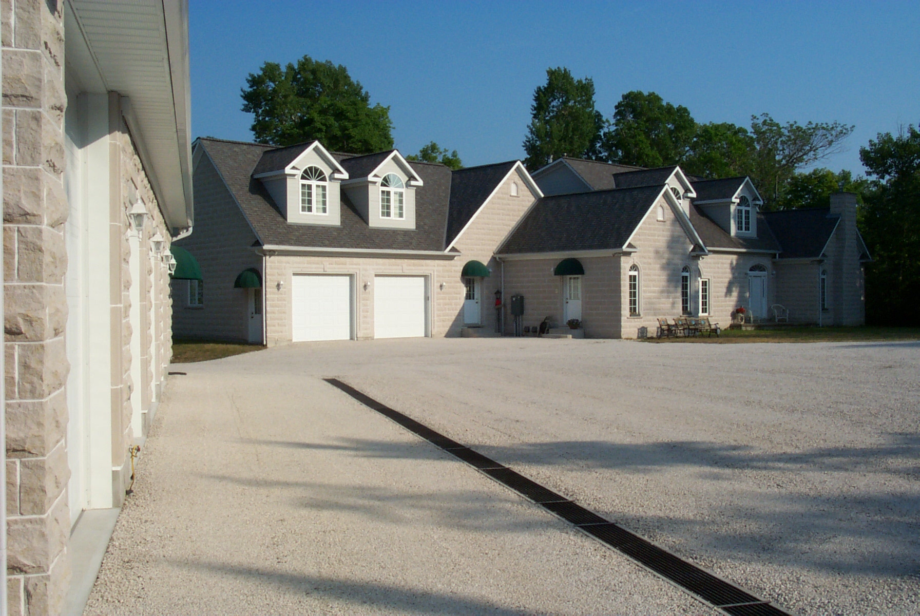 A grey house with two white garage doors