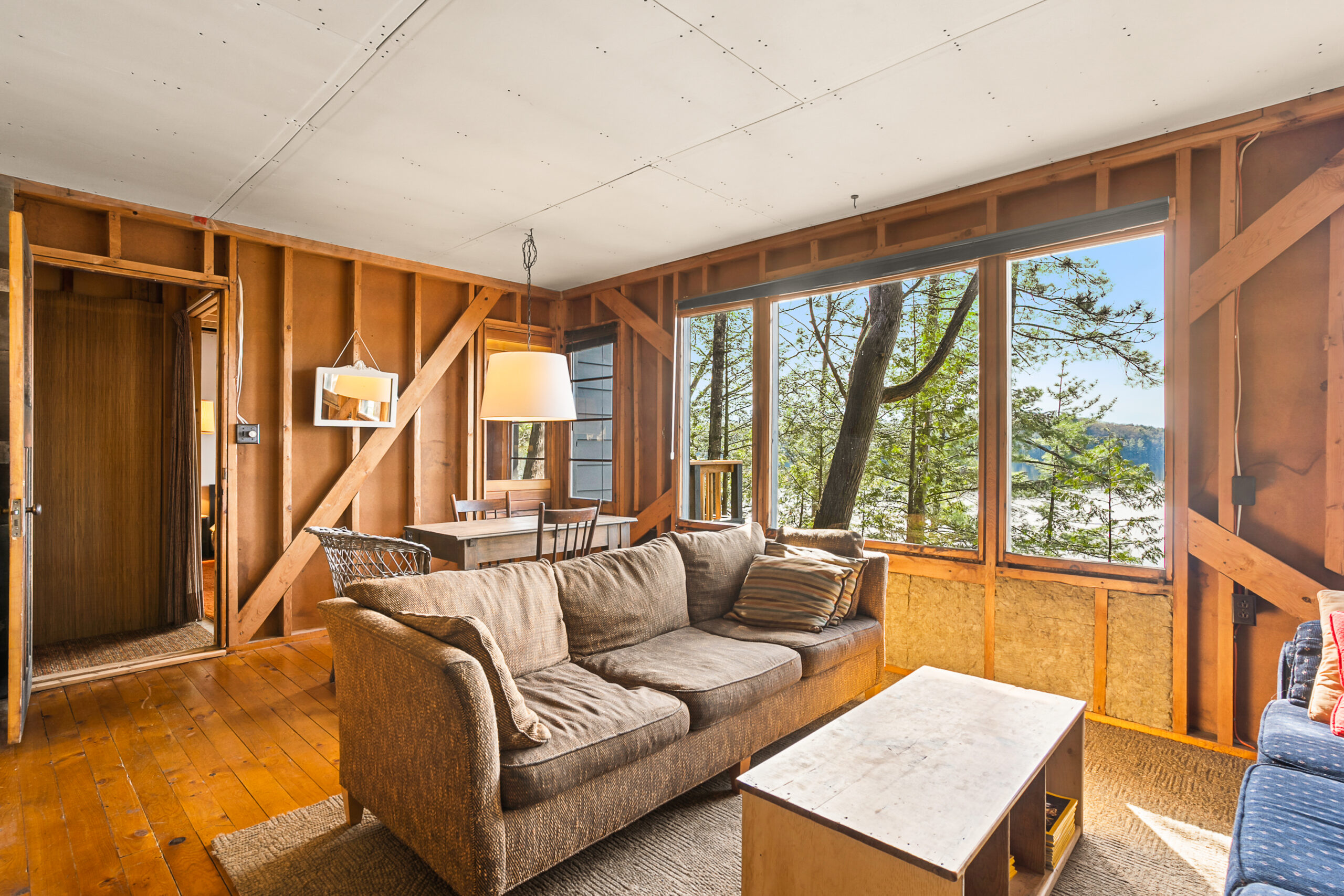 A brown couch faces a small brown table