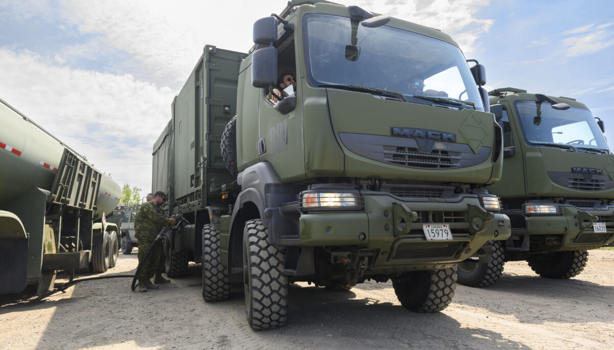 Military truck being fuelled by solider.