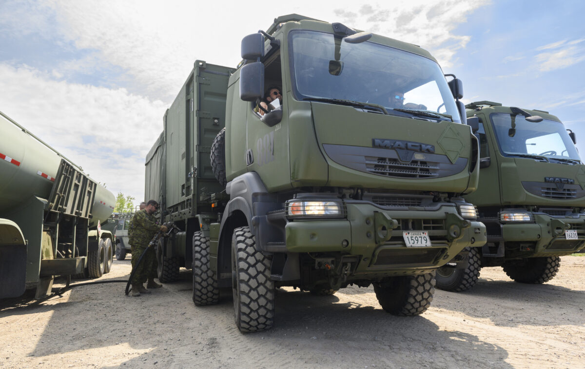 Military truck being fuelled by solider.