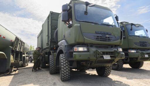 Military truck being fuelled by solider.