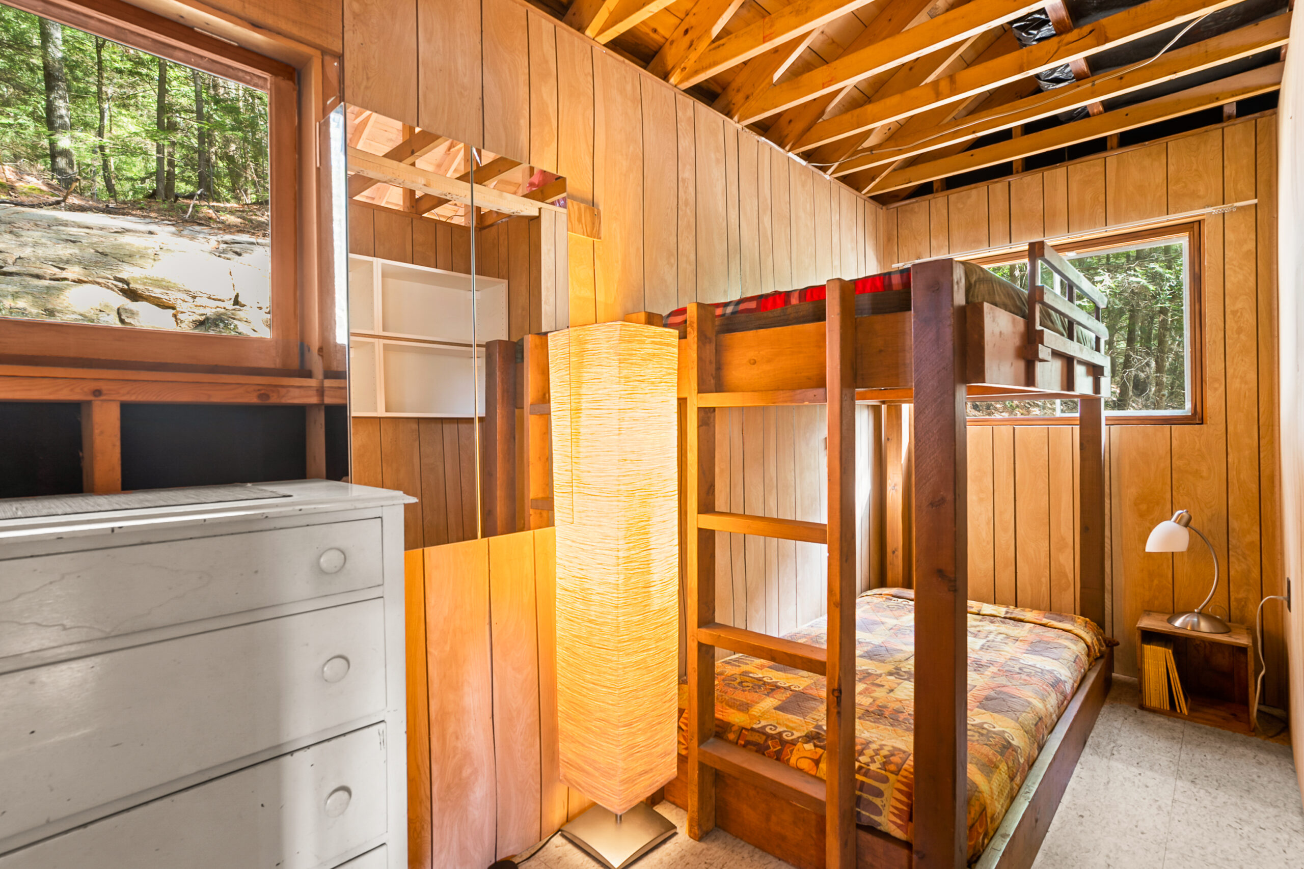A brown room with wooden bunk beds