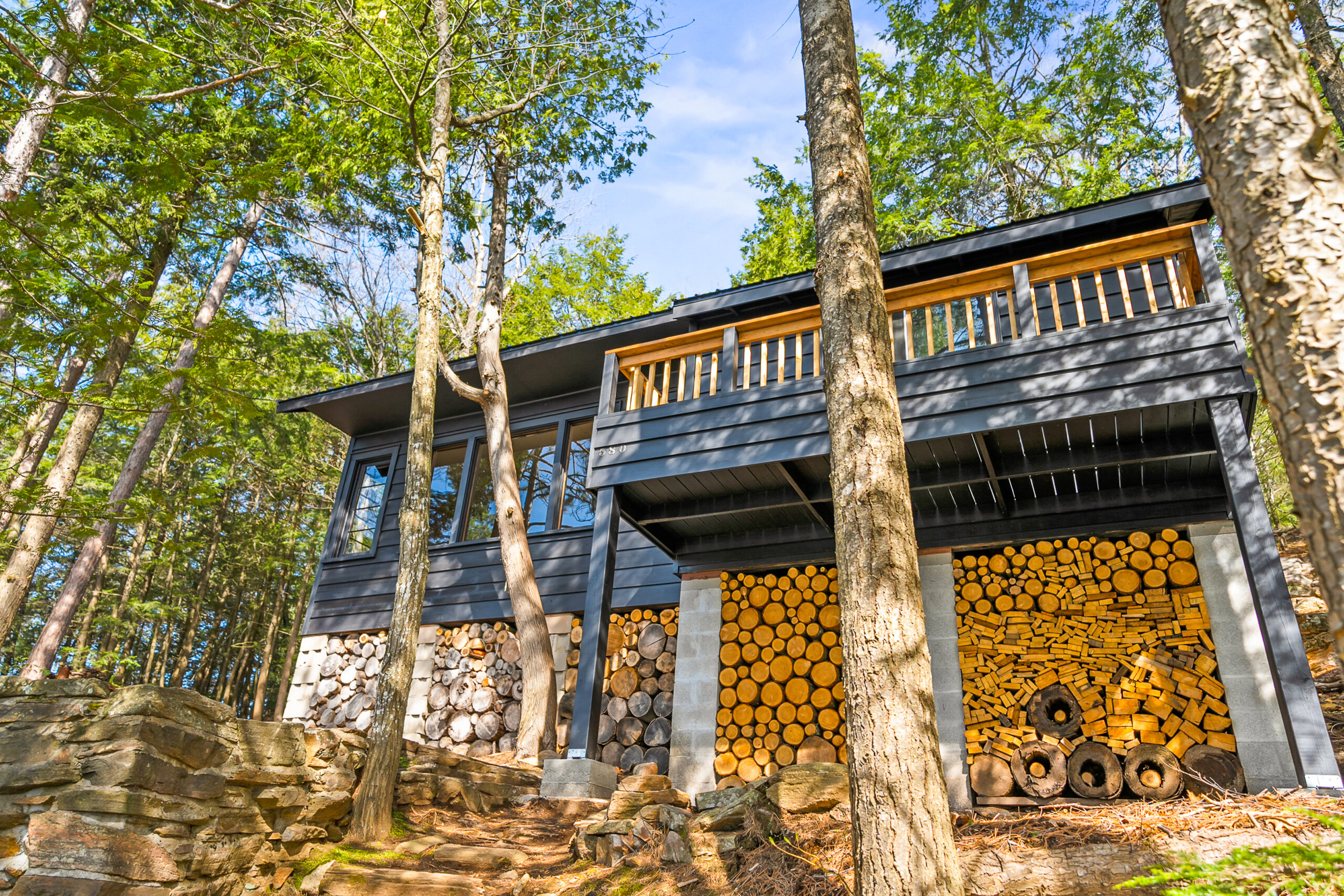 From the sloped property, the dark grey cottage looks big
